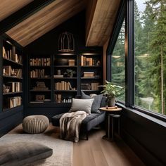 a living room filled with lots of furniture and bookshelves next to a window