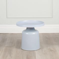 a white table sitting on top of a hard wood floor