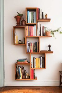 a bookshelf filled with lots of books on top of a hard wood floor