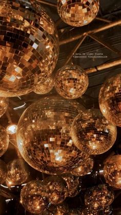 many shiny disco balls hanging from the ceiling