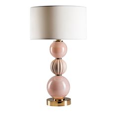 a lamp with three balls on it and a white lampshade over the top