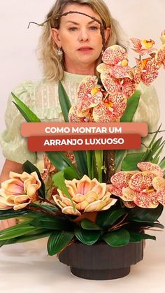 the woman is holding a bouquet of flowers in front of her face and looking at the camera