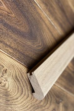 a close up view of a wooden door frame with woodgrain on the side