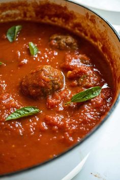 a pan filled with meatballs and tomato sauce