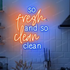 a neon sign that says so fresh and so clean on the wall in a kitchen