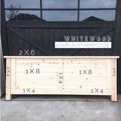 a wooden bench with numbers on it in front of a barn door that says whitewood fourfax farmhouse