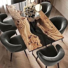 a dining room table with chairs around it and a vase filled with flowers on top