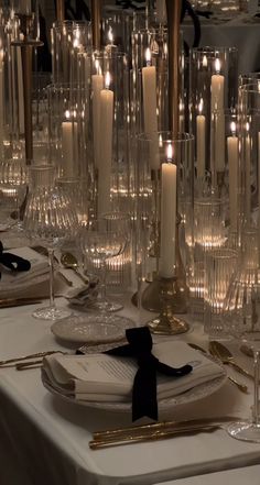 the table is set with candles and place settings