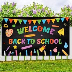 a welcome back to school sign in front of a fence