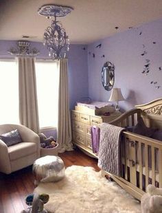 a baby's room with purple walls and white furniture