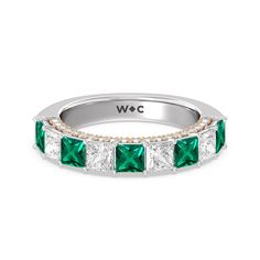 A standout sparkler. This half-eternity ring that's perfect as an anniversary ring epitomizes glowing beauty. Half of the band is traced with created Emerald princess-cut on a prong setting. Underneath the princess created Emerald is an arch of petite round diamonds set on prongs in a different metal tone. The two-toned look and the continuous sparkle give this piece a fashion-forward style plus lots of personality. Fine Jewelry Princess Cut Diamond Emerald Ring, Anniversary Princess Cut Emerald Ring, May Birthstone, Emerald Gemstones For Anniversary - Fine Jewelry, Elegant Multi-stone Emerald Ring In Platinum, Luxury Multi-stone Emerald Ring In White Gold, Round Diamond Setting, Gorgeous Engagement Ring, Half Eternity Ring, Emerald Gemstone