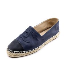 Cool and practical, these Chanel espadrilles are a comfortable summer essential that will turn heads. Crafted in Spain, these designer espadrilles present a soft navy lambskin exterior, matching navy CC logo patch at the vamps, and a contrasting black cap toe. A beige jute trim showcases the brand's high-end craftsmanship, while the rubber sole provides some traction. For a simple weekend outfit, wear these Chanel espadrilles with your favorite blue t-shirt, white cropped jeans, and an effortless designer tote. Blue Leather Espadrilles With Woven Sole, Blue Leather Espadrilles With Textured Sole, Blue Leather Slip-on Espadrilles, Blue Leather Espadrilles For Beach, Blue Leather Espadrilles For The Beach, Blue Leather Beach Espadrilles, Blue Leather Espadrilles With Rubber Sole, Navy Casual Espadrilles For Summer, White Cropped Jeans