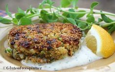 a plate with crab cakes and lemon wedges