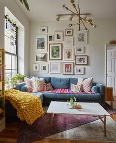 a living room filled with furniture and pictures on the wall