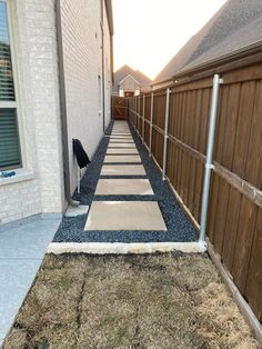 the walkway is lined with stones and gravel