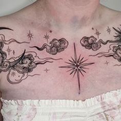 a woman's chest with stars and clouds on it