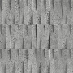 a gray brick wall textured with small squares and lines in varying sizes, from diagonal to horizontal