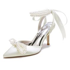 a pair of white shoes with pearls on the heel