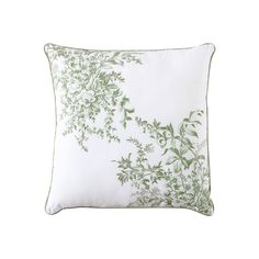 a white pillow with green leaves on it