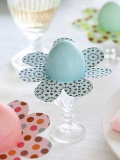 an egg sitting on top of a table next to napkins and glasses filled with eggs