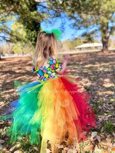 This high low tutu is next level. The front is an Ombre green and topped with a shiny gold bow. The back is over 100 yards of tulle with tiered layers creating a wild rainbow look. The back layers have glitter tulle mixed in. Sizing Info: 1-3T is roughly 6" long in the front, 20" long in the back 4-5T is roughly 8 inches long in the front, 25" long in the back 6-8 years is roughly 10 long in the front, 30" long in the back Playful Rainbow Tutu Dress For Spring, Fitted Multicolor Tutu Dress With Ruffles, Spring Rainbow Tutu Dress With Ruffles, Fun Multicolor Tutu Dress For Dress-up, Rainbow Tutu Dress For Summer Party, Playful Rainbow Tutu Dress For Dress-up, Rainbow Playful Tutu Dress For Dress-up, Fitted Glitter Tulle Tutu Dress For Summer, Whimsical Multicolor Fitted Tutu Dress