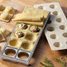 an assortment of pastries are sitting on a tray next to muffin tins