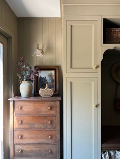 a wooden dresser sitting next to a window