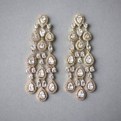 Designed with pave set pear-shaped CZ gemstones and miniature pear accents, these layered wedding earrings are certain to capture attention. Their delicate design exudes luxurious elegance. These post-back pierced earrings are rhodium or gold plated, measure 2.5 inches long and .75 an inch wide, grade AAA CZ, and are lead, cadmium, and nickel free. Wedding Earring, Delicate Design, Silver Drop Earrings, Gold Drop Earrings, Pierced Earrings, Layered Look, Pear Cut, Wedding Earrings, Earings Piercings