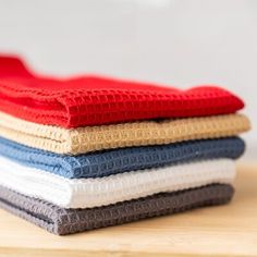 four different colored cloths stacked on top of each other