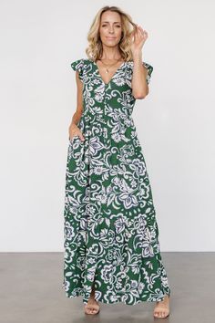 Beautiful flowy dress for warm days Lightweight Georgette material Green background with Cream and Navy Blue botanical print Fit runs big, we recommend sizing down V-neckline Cap style flutter sleeve Functional buttons down front of dress, end at bottom tier Subtle gathering at waist Hidden side pockets Single bottom tier Lined bodice, skirt lined to the tier Self: 98% Polyester, 2% Spandex Lining: 97% Polyester, 3% Spandex Trina is 5'6, cup size 32D, size 2 and is wearing size XS Casual V-neck Maxi Dress With Ruffles, Casual Maxi Dress With Floral Print And Flutter Sleeves, Casual V-neck Printed Maxi Dress, Green Flutter Sleeve Maxi Dress For Summer, Green Flutter Sleeve Maxi Dress For Beach, Green Printed V-neck Maxi Dress, Casual V-neck Maxi Dress With Floral Print, Casual V-neck Floral Print Maxi Dress, Green Flutter Sleeve Maxi Dress For Vacation