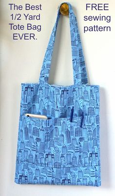 a blue tote bag hanging on a white wall with an orange object in it