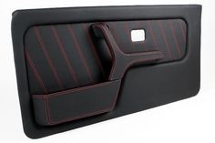 a black and red car seat with two matching armrests on the back of it