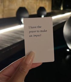 a person holding up a card with the words i have the power to make an impact