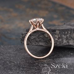 a rose gold engagement ring with an oval cut diamond