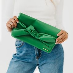 Meet our new favorite bag for every occasion, our Billie Bow Clutch Bag! Available in 5 colors, this bag features a bow on the front, our 3 sisters studs in the corner, a back exterior pocket, an interior zipper pocket, and a chain strap inside. Style it as a clutch, crossbody, or shoulder bag and get ready for a fashion forward day! The Billie Bow Clutch Bag is another addition to our 3 Sisters Collection! This collection is inspired by the unbreakable bond shared between the owner/founder of P Bow Clutch, 3 Sisters, In The Corner, British Indian, Turks And Caicos Islands, Running Women, Trinidad And Tobago, Chain Strap, Zipper Pocket