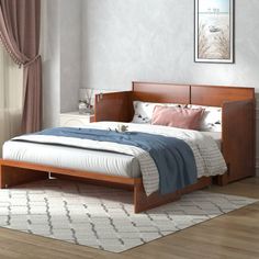 a bed sitting on top of a wooden floor next to a window