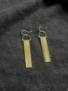 "Lightweight and eye-catching fringe earrings. 2 7/8\"l x 5/8\"w  Brass with gold-fill ear hooks" Gold Fringe Earrings In Brass, Gold Fringe Drop Earrings, Gold-tone Long Drop Linear Earrings, Gold Long Drop Chandelier Earrings With Tassels, Gold Fringe Chandelier Earrings, Gold Fringe Metal Chandelier Earrings, Metal Fringe Dangle Earrings, Fringe Dangle Metal Earrings, Long Drop Brass Chandelier Earrings