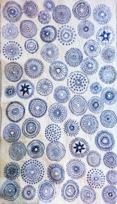 a blue and white quilt with circles on it