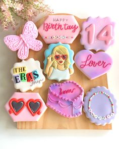 decorated cookies are arranged on a cutting board