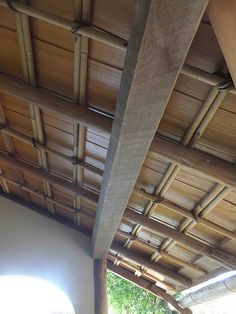 the inside of a building with wooden roofing