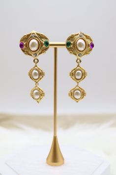 These matte gold tiered drop clip-on earrings feature an array of multi-colored stones arranged in a graceful cascading design. The vibrant stones set against the subtle matte gold create a striking contrast, making these earrings a bold and fashionable choice for those without pierced ears. Length: 2.50” Width: 1.14” Closure: Clip-On Earrings Material: Brass with 18K Gold Plating with Rhodium Coating Lead Free and Hypoallergenic Elegant Multicolor Clip-on Earrings, La Wedding, Colored Stones, Holiday Jewelry, Wedding Weekend, Dream Jewelry, Pierced Ears, Matte Gold, Instagram Shop