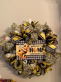 a yellow and black wreath hanging on the side of a wall with an animal theme