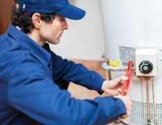 a man is working on an electric water heater