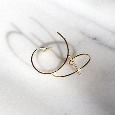 This adorable little wire hoop has a T-bar on the front and moves behind the ears to create the perfect hunger hoop. High quality and special design will give you something special. These earrings are available in sterling silver with gold plating and are great for sensitive ears! ⭐️Taking Care of Your Jewelry⭐️ To ensure your pieces stay bright and shiny for as long as possible, keep them away from chemicals such as perfume and chlorine, and store them in a cool dry place in an individual pour of box to avoid your jewelry tangling or scratching each other. All my jewelry is made with high quality materials and comes in a beautiful box with a 100% organic cotton jewelry bag for storage, you'll love it! 🧡Thank you for Coming to Hyew1Jewelry Studio! If you have any question feel free to con Minimalist Wire Wrapped Yellow Gold Hoop Earrings, Minimalist Yellow Gold Wire Wrapped Hoop Earrings, Modern Wrap Earrings For Pierced Ears As Gift, Modern Hoop Ear Cuff With Ear Wire, Yellow Gold Hoop Ear Cuff For Gift, Yellow Gold Hoop Ear Cuff As Gift, Cotton Jewelry, Jewelry Bag, Sensitive Ears