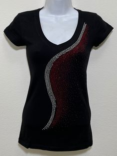 Fabric is comprised of 95% cotton and 5% spandex.  Handmade rhinestone t-shirts made in the United States with quality rhinestones. Machine washable. T-shirt style is a fitted V-neck cap sleeve. Size Range:         XXS = 2         XS = 4         S = 6         M = 8         L = 10         XL = 12 Cotton Tops With Rhinestones And Short Sleeves, Stretch Crew Neck Top With Rhinestones, Fitted Cotton Top With Rhinestones, Cotton Short Sleeve Top With Rhinestones, Rhinestone Cotton Tops With Short Sleeves, Fitted V-neck Top With Rhinestones, Cotton Rhinestone Short Sleeve Top, Embellished Fitted Cotton T-shirt, Fitted Cotton Embellished T-shirt