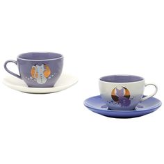 two cups and saucers with designs on them