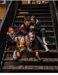 two people and a dog sitting on some steps