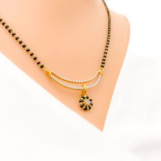 Elevate your style with our Floral Black Bead Drop Mangal Sutra. Crafted in 18k yellow gold, the diamond pendant boasts 0.56 ct diamonds in round brilliant cut, while the 22k black bead chain adds a bold contrast. Weighing 3.6 grams, this necklace is 19.5 inches long with an adjustable hook lock. PRODUCT DETAILS Diamond Pendant Gold Purity(karat): 18k Item Weight(grams): 3.6 Item Finish: Yellow Gold Stone: Diamond Diamond Weight(carats): 0.56 ct Diamond Color: F-G Diamond Quality: VS Diamond Sha Gold Necklaces With Black Diamonds, Black 22k Gold Jewelry With Round Beads, Traditional Yellow Gold Jewelry With Black Beads, Black 22k Gold Necklace For Weddings, Traditional Black Jewelry With Round Pendant, Gold Jewelry With Black Diamonds, Traditional Black Diamond Necklace, Traditional Black Round Pendant Jewelry, Black 22k Gold Jewelry As A Gift