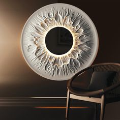 an eyeball shaped light fixture in the shape of a human eye on a wall next to a chair