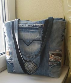 Upcycled denim, distressed denim bag, big jeans tote bag, denim zippered shopper, handmade denim laptop carrying case, denim shoulder bag. This denim bag was made from upcycled distressed jeans. It is rather big and roomy. It can be used as a tote bag, a shopper, a laptop carrying case. The bas has four outside pockets and a pocket inside. It is lined with a cotton fabric.  It can make a perfect present for a person who likes jeans and denim fabric.  This shoulder denim bag will be usefull and functional in everyday life. It can be washed if necessary.   The size is 40 cm x 35cm x 6 cm. bottom (16 x14 x 2.5 in. bottom)   This very bag was made to order. I will make a similar one for you.  Please mind that it can be a bit different as it depends on the jeans upcycled. Thank you for visiting Handmade Denim Tote Shoulder Bag, Everyday Distressed Denim Bag, Casual Distressed Denim Shoulder Bag, Distressed Denim Blue Bag For Everyday Use, Everyday Distressed Denim Blue Bag, Blue Cotton Jeans For Everyday Use, Trendy Denim Jeans For Everyday Use, Everyday Distressed Tote Bag, Handmade Denim Shoulder Bag For Everyday Use